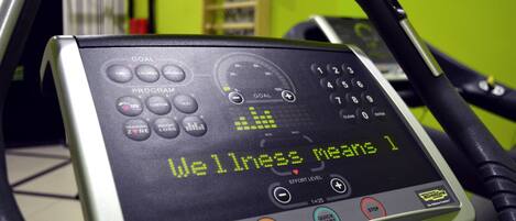 A fitness machine with a digital display and control panel.