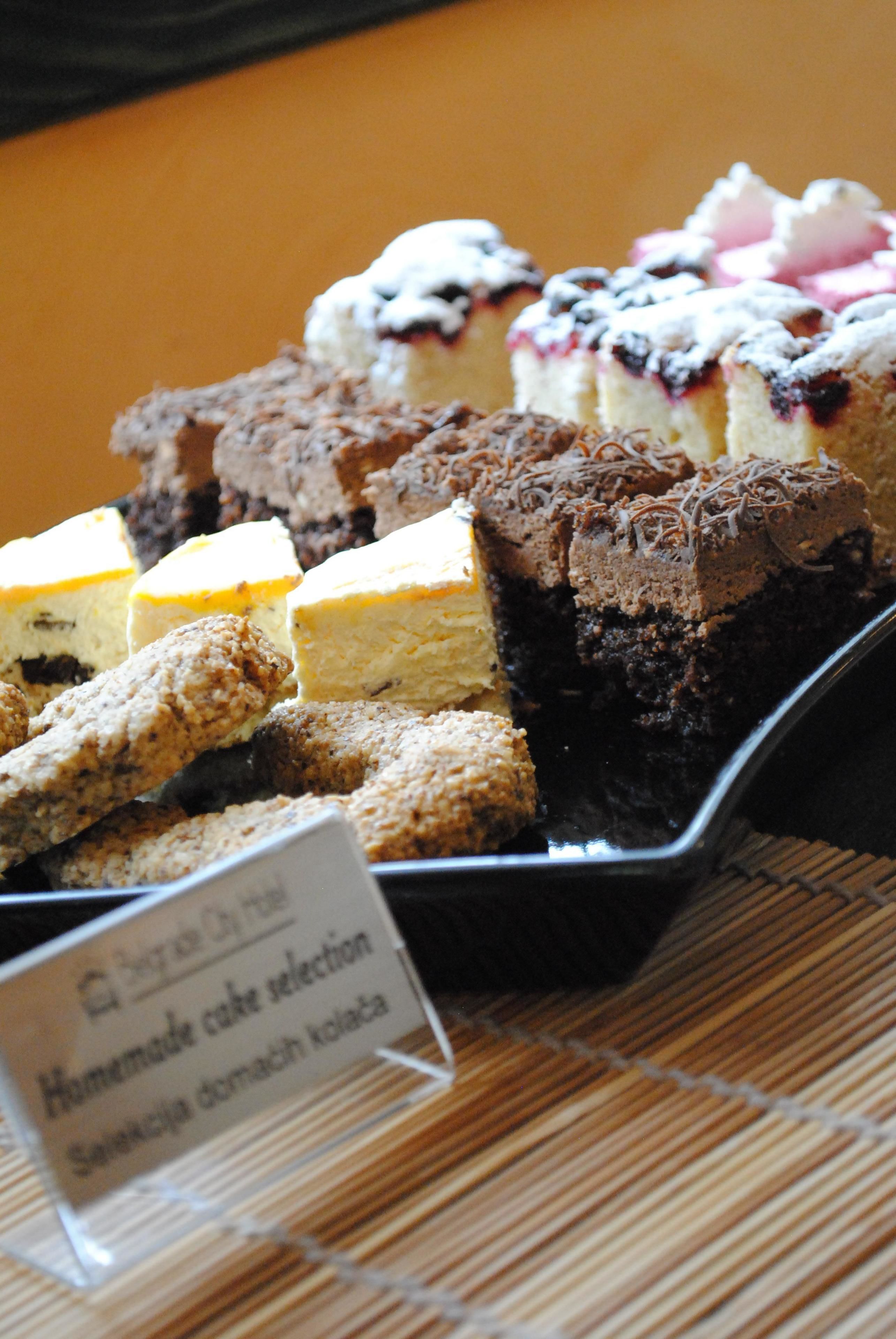 A display of various cakes and pastries on a tray.