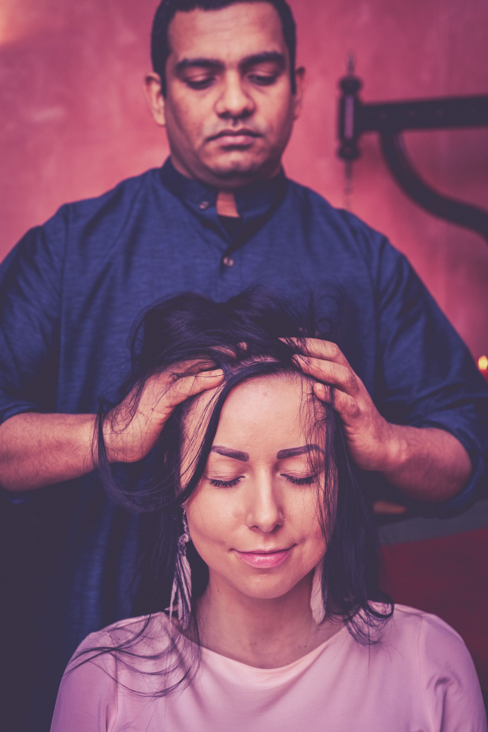 A person with their hair being styled by another individual.