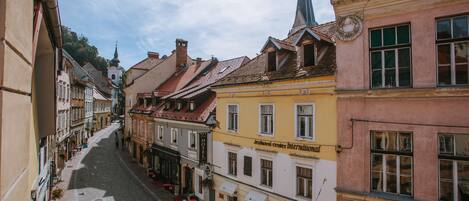 A cobblestone street lined with historic buildings, including a hotel with a sign for a center international.