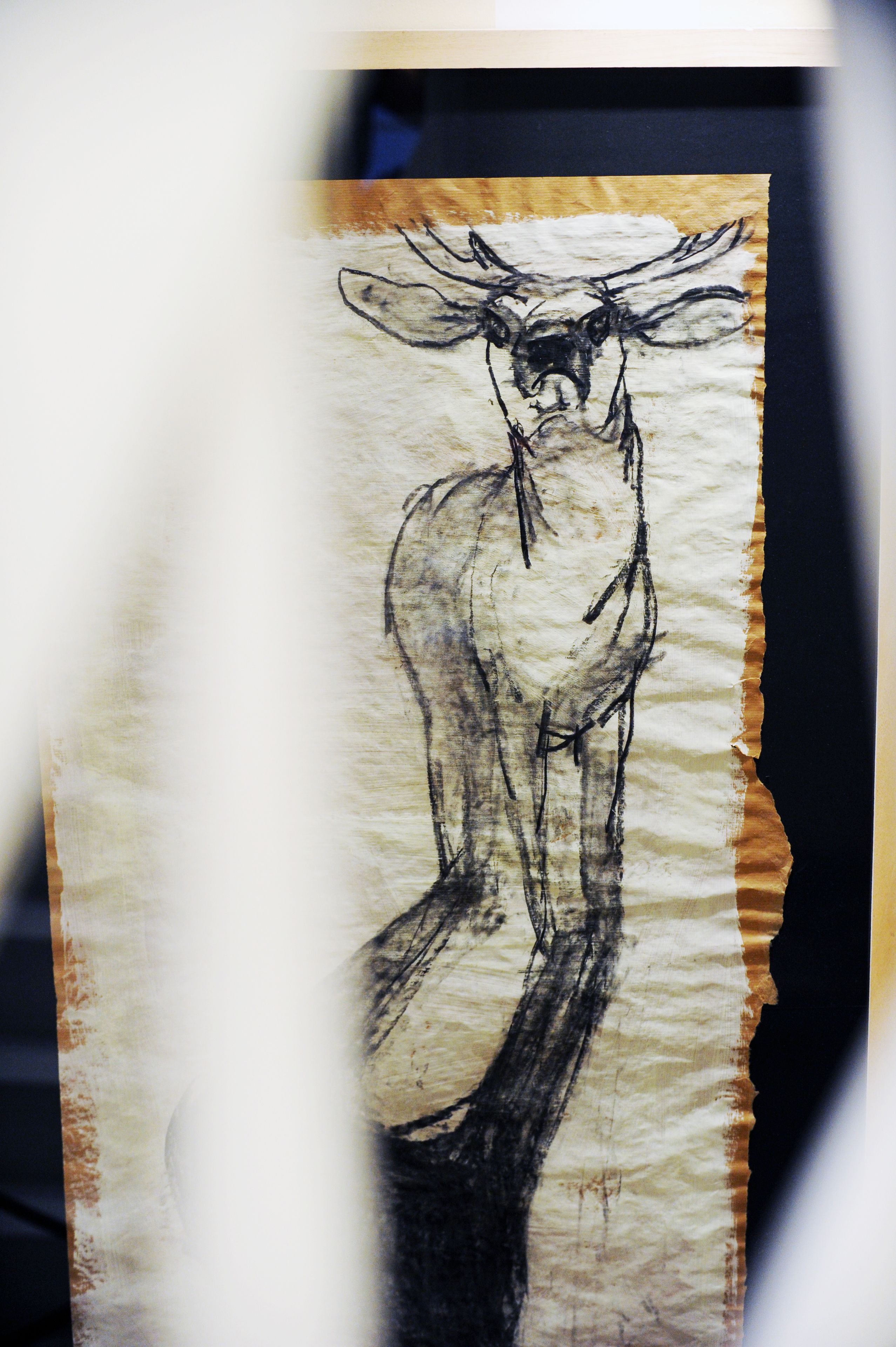 A drawing of a moose on a piece of paper.