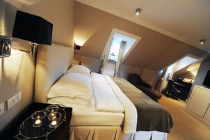 A bedroom with a bed, bedside table, and a desk area with a chair.