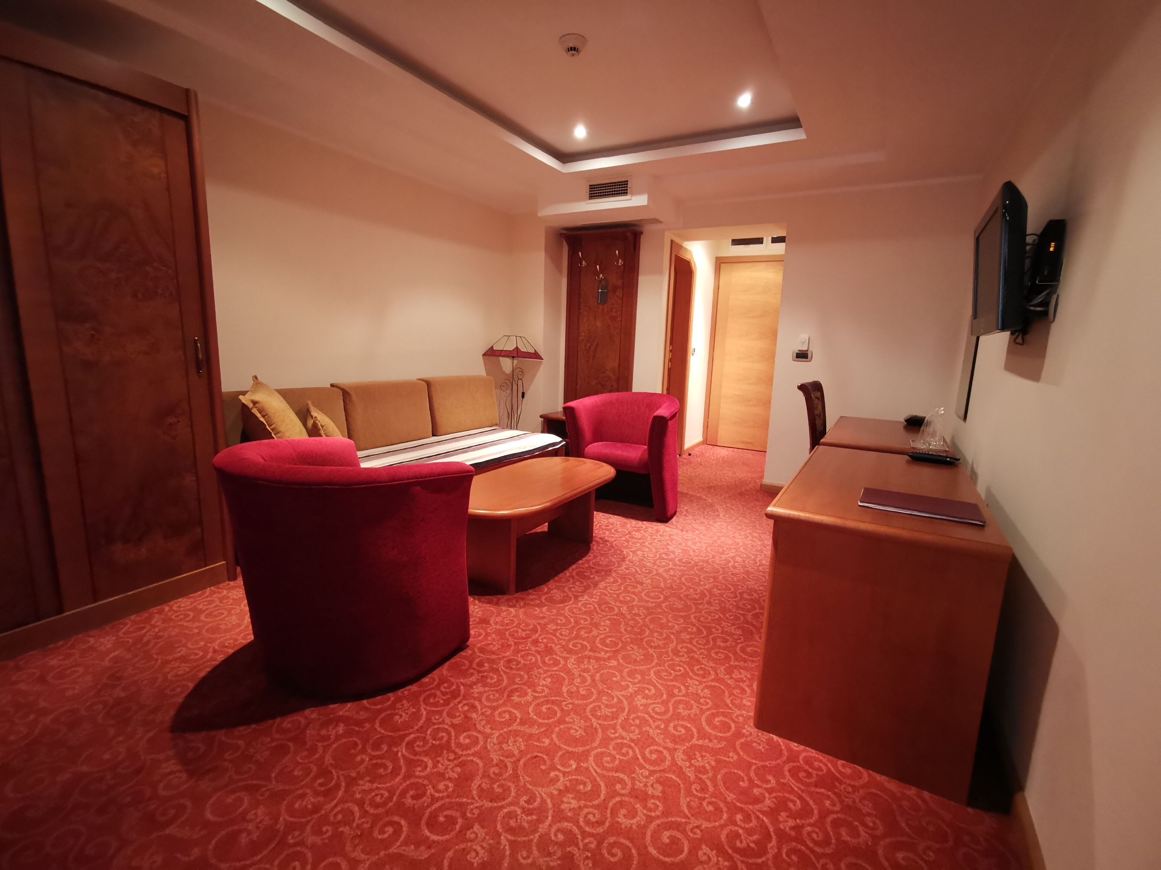 deluxe triple room | living area | tv