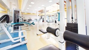 A gym with various exercise equipment, including weight machines and free weights.