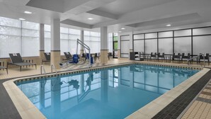 An indoor swimming pool with clear water, surrounded by lounge chairs and a staircase leading to a higher level. - Courtyard Pittsburgh Airport Settlers Ridge (Pittsburgh)