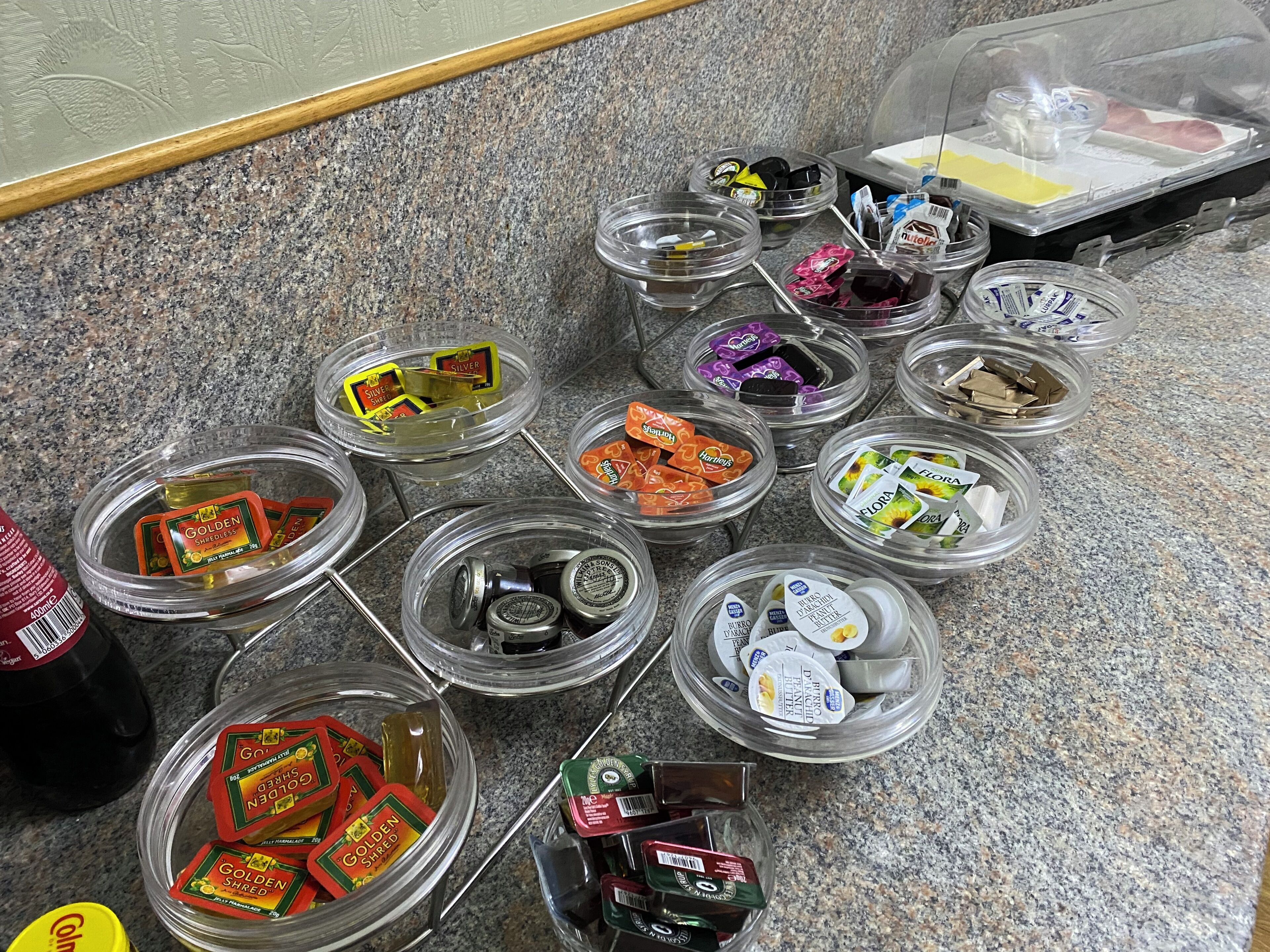 A variety of food items and condiments arranged on a granite countertop.