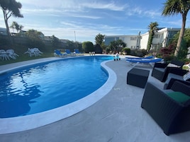 Seasonal outdoor pool, pool umbrellas, pool loungers