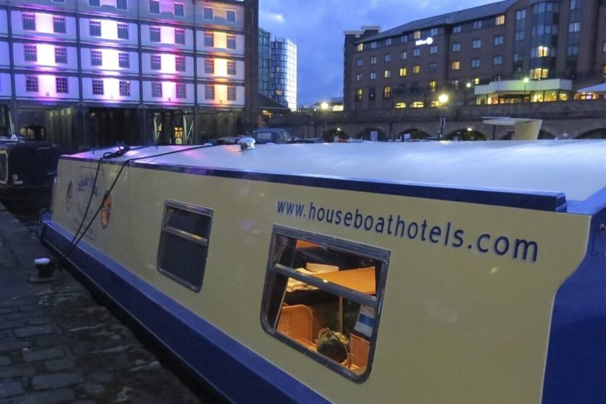 A houseboat with a website address and a window.
