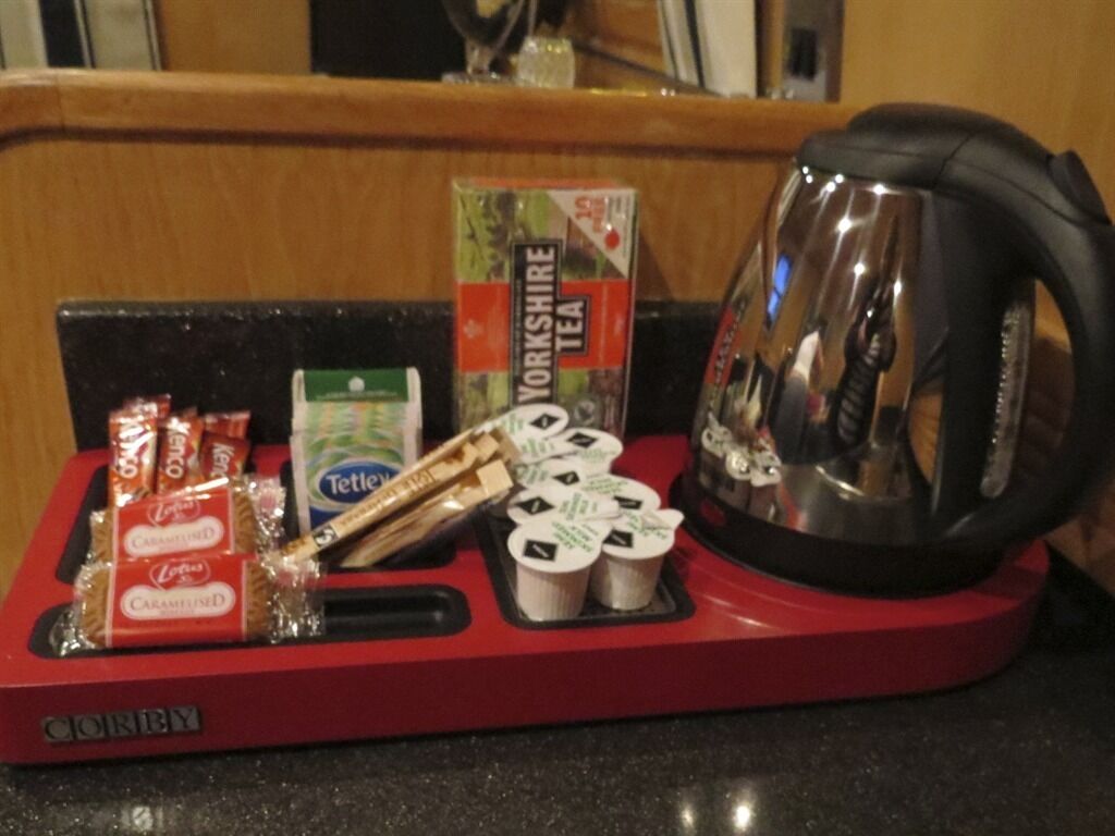 A kitchen counter with a Yorkshire Tea box, a kettle, and some snacks.