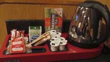 A kitchen counter with a Yorkshire Tea box, a kettle, and some snacks.