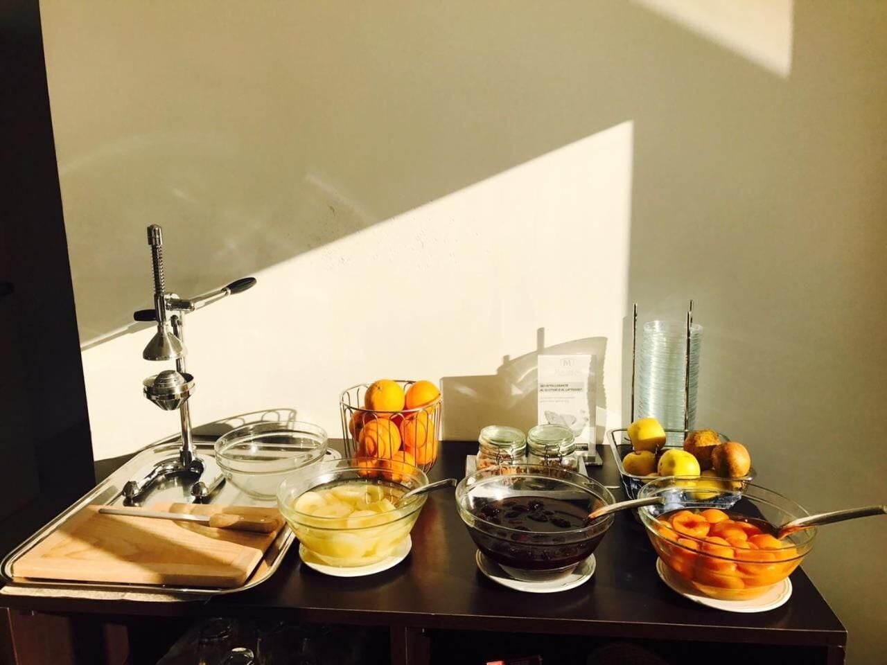 A breakfast buffet with various food items and utensils.