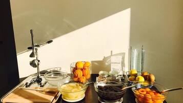 A breakfast buffet with various food items and utensils.