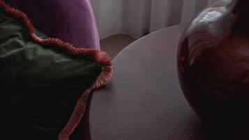 A close-up of a purple and green upholstered chair with a textured surface.