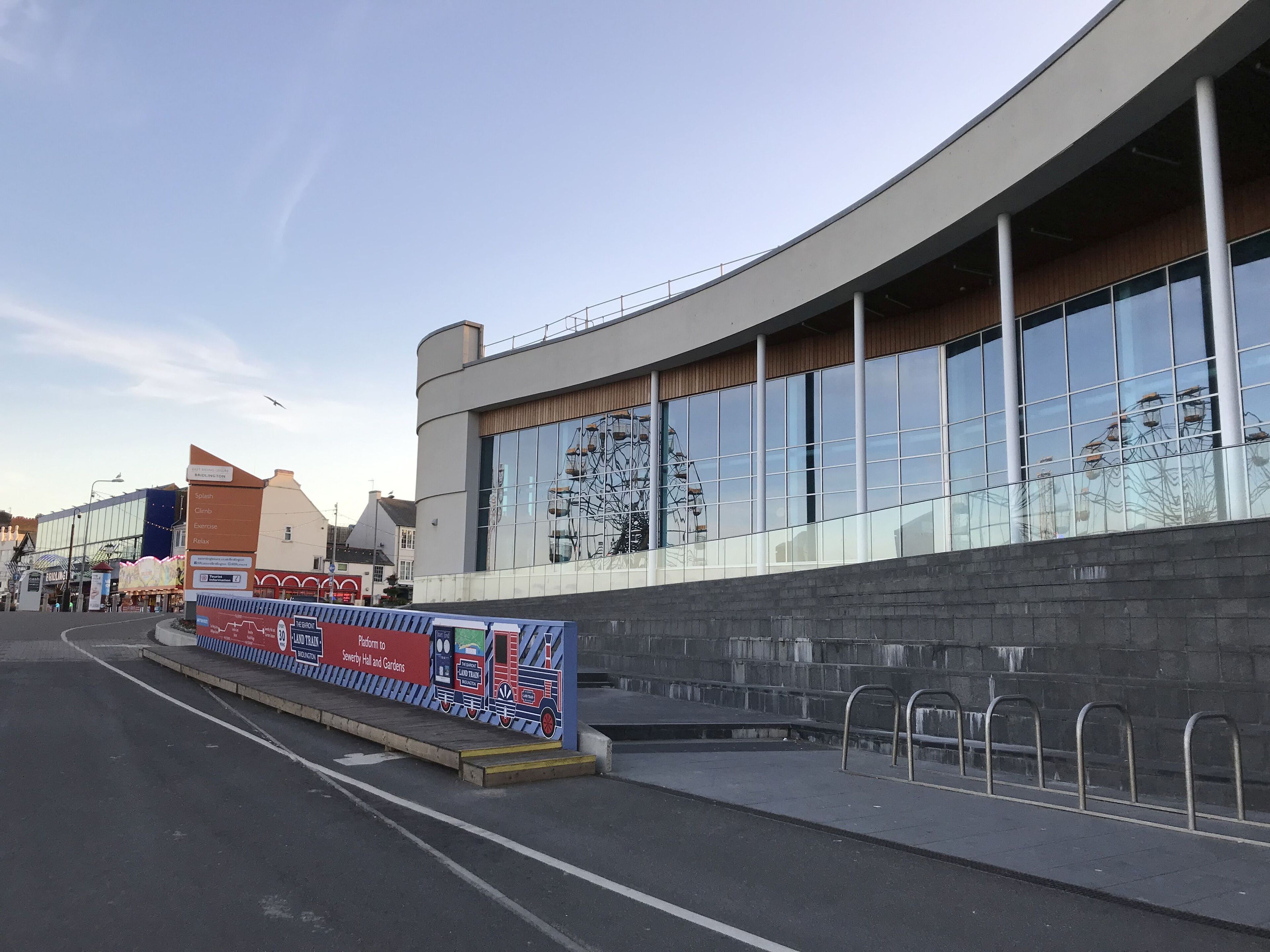 A modern building with large windows and a curved facade.