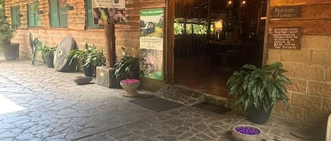 Un edificio rustico in legno con un cartello che dice 'OPEN'.