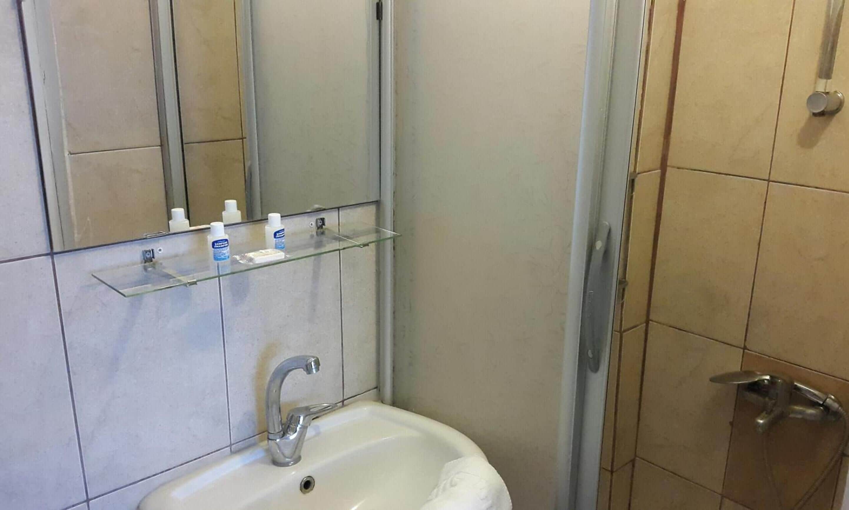 shower, hair dryer, slippers, towels