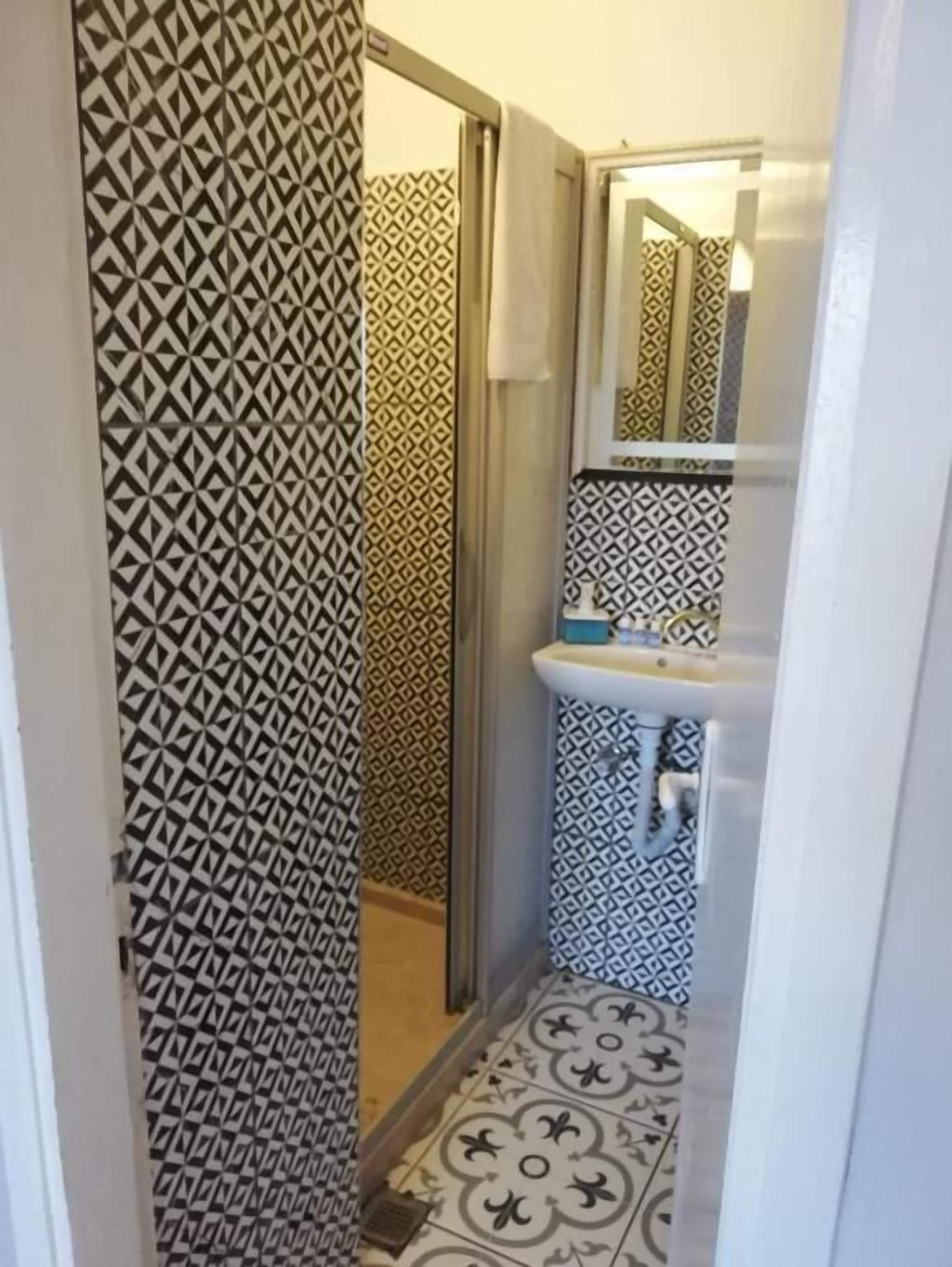 shower, hair dryer, slippers, towels