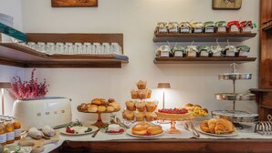 A buffet setup with various food items, including pastries, fruits, and condiments. - Hotel Il Tiglio (Castel di Sangro)