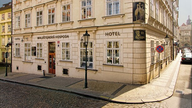A historic building with a sign reading "Waldsteinska Hospoda Hotel." It features a classic European architectural style with multiple windows and a prominent entrance. - Hotel Three Storks (Prague)
