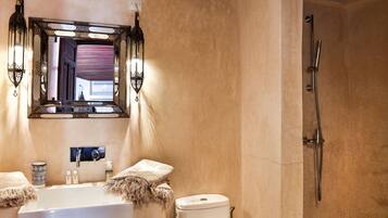 A bathroom with a sink, toilet, and shower.