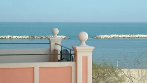 A balcony with a view of the sea, a railing, and a stone wall. - Aurora (Rimini)