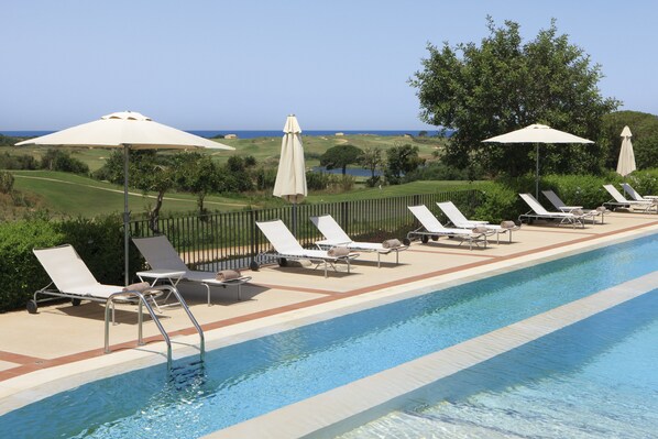 Piscine couverte, piscine extérieure, parasols de plage, chaises longues
