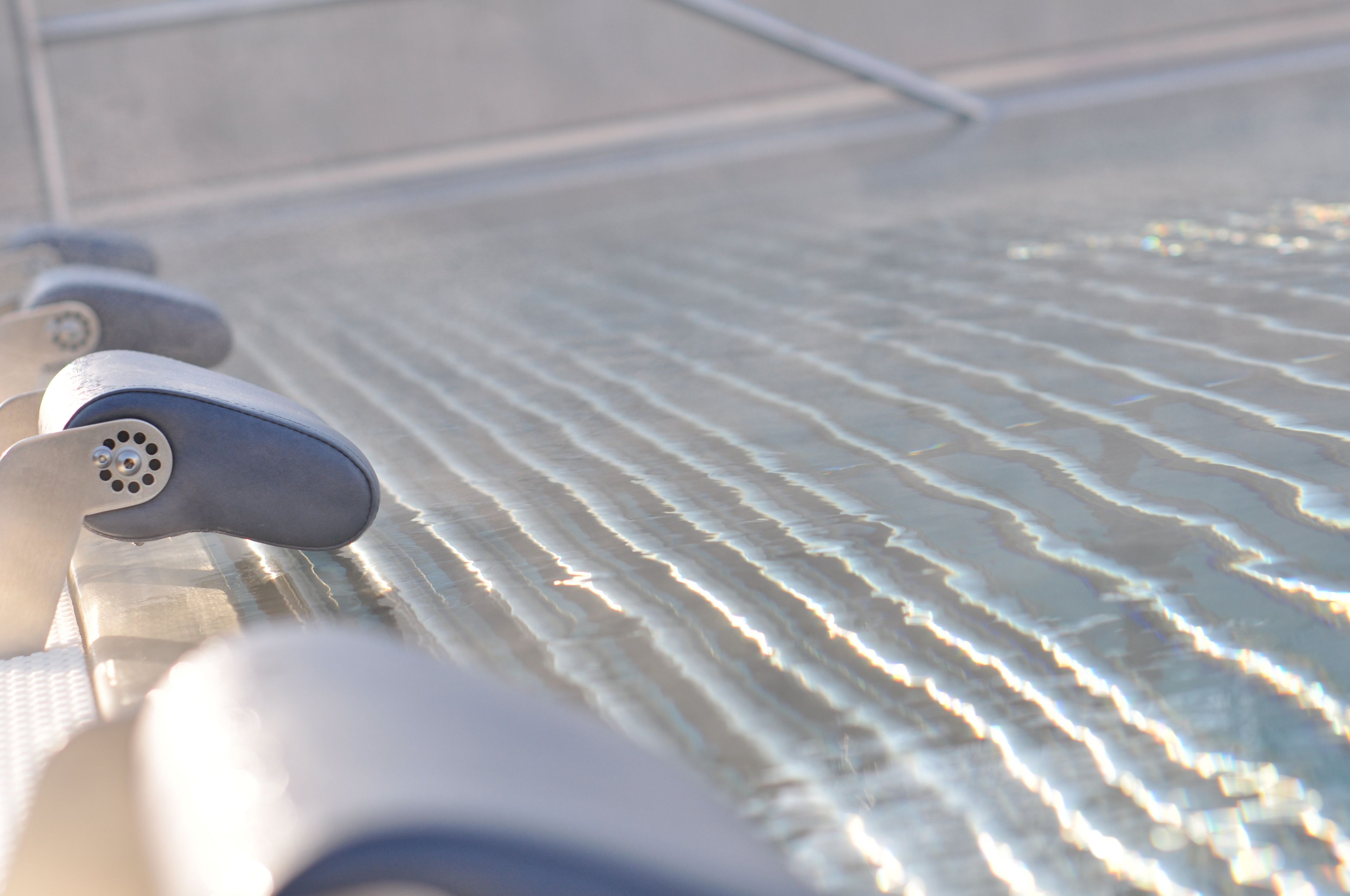 A close-up of a textured surface with a metallic object, possibly a part of a chair or furniture.