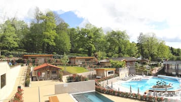 Ein Resort mit Swimmingpool, Liegestühlen und Bergblick.
