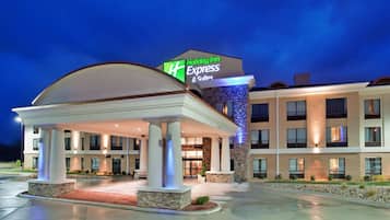 A Holiday Inn Express hotel with a covered entrance, multiple floors, and a well-lit facade.