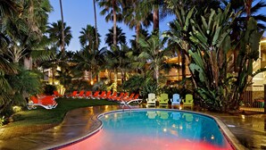 A swimming pool with lounge chairs and palm trees. - Ocean Palms Beach Resort (Carlsbad)