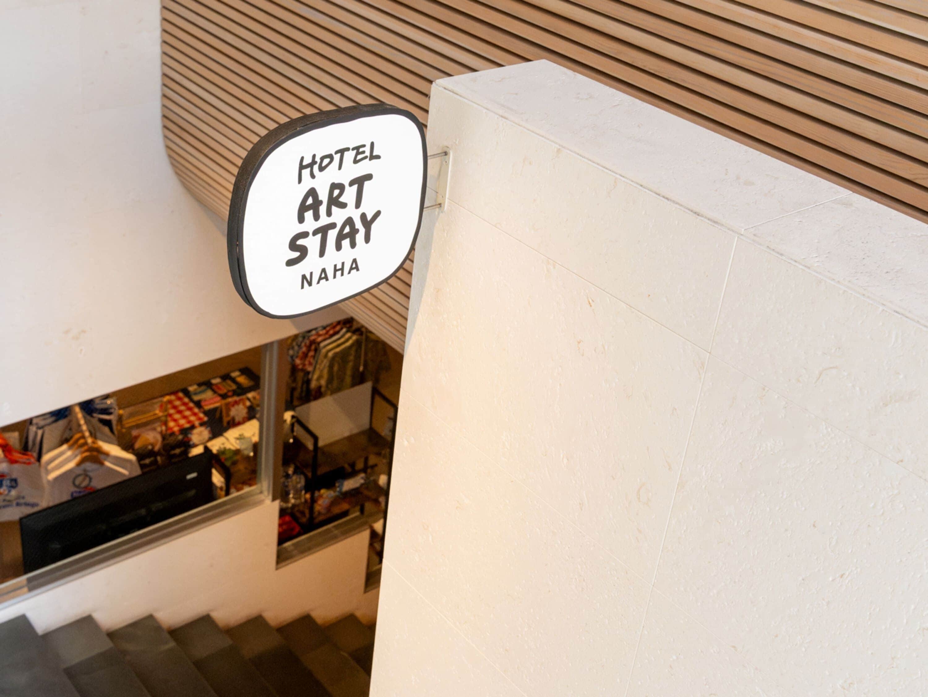 A sign for a hotel art stay.