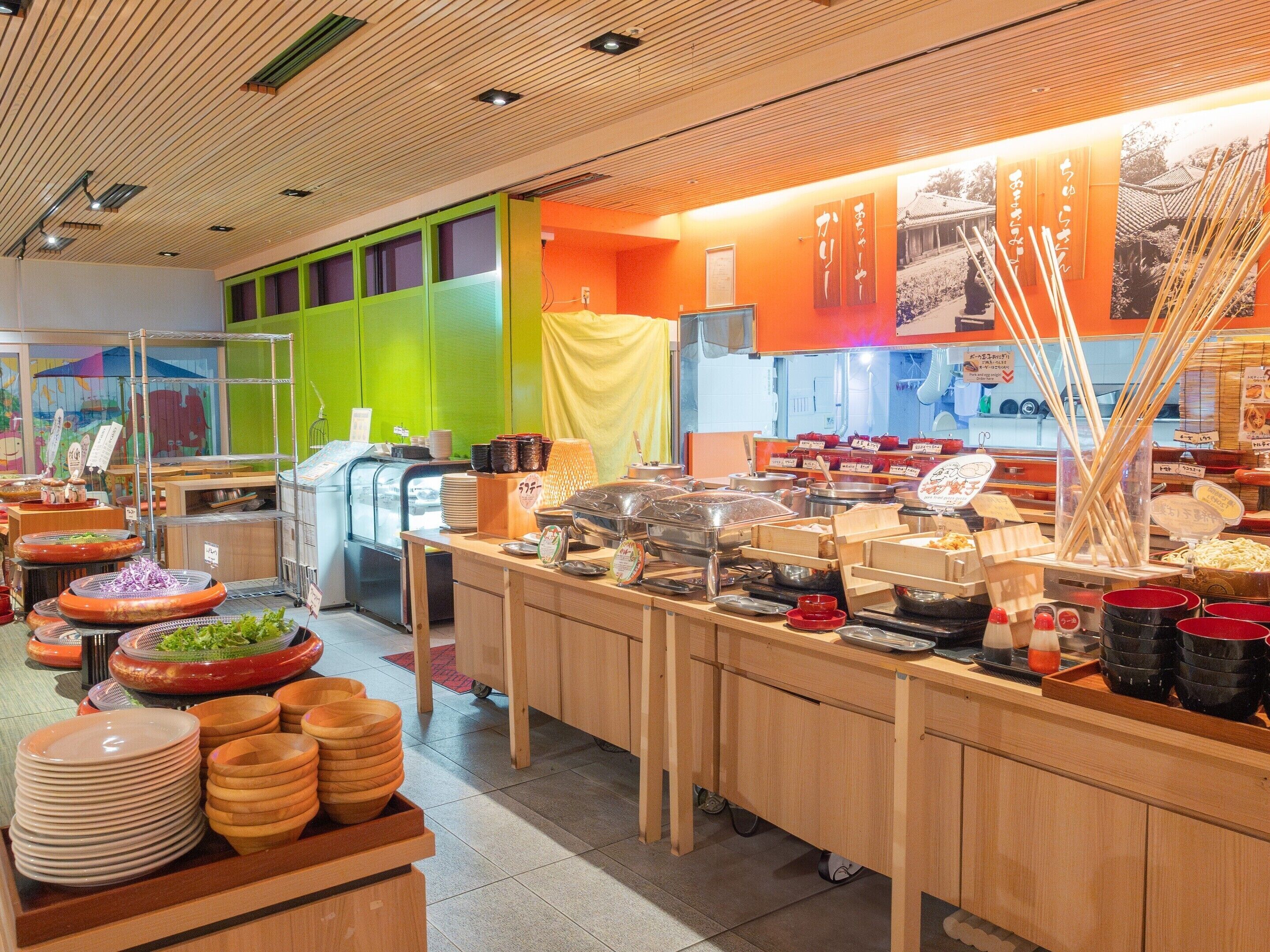 A buffet setup with various food items and utensils.