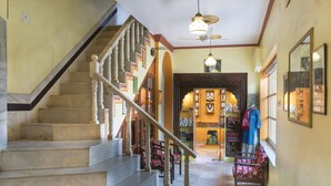 A staircase leading to a shop with various items on display. - Hotel Harmony (Khajuraho)