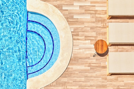 Outdoor pool, open 10:00 AM to 6:00 PM, pool umbrellas, sun loungers