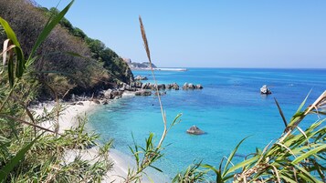 Beach nearby, white sand, beach umbrellas, beach towels