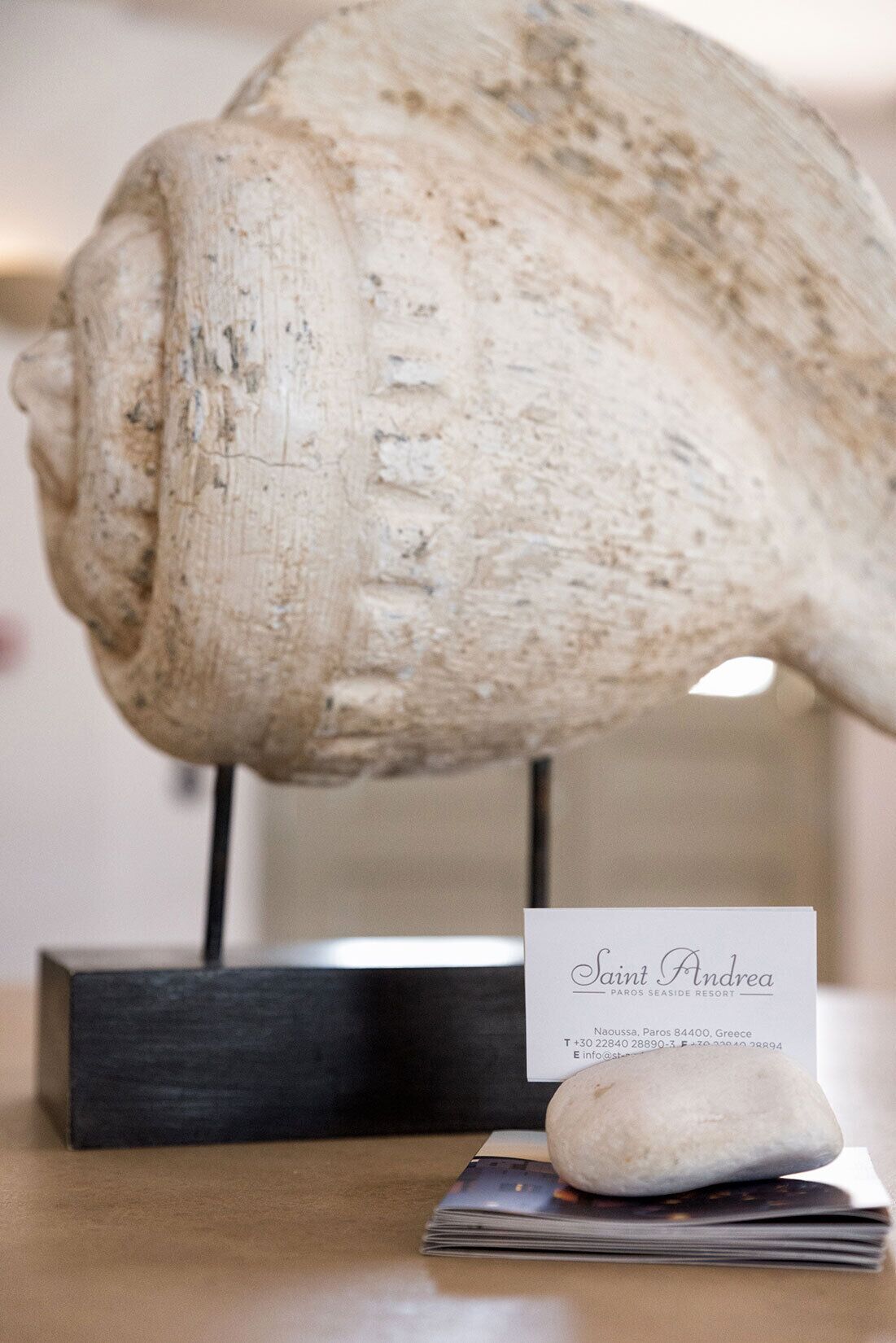 A large shell on display with a sign reading "Saint Andrea Paros Seaside Resort."