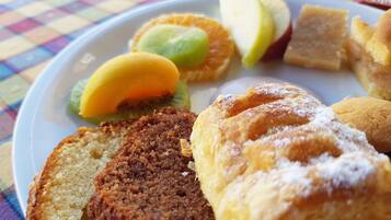 A plate with various pastries and fruits.