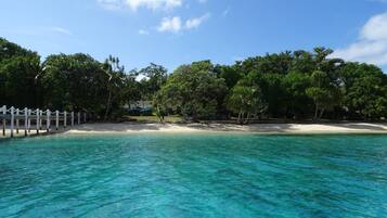 Private beach, white sand, sun loungers, beach umbrellas