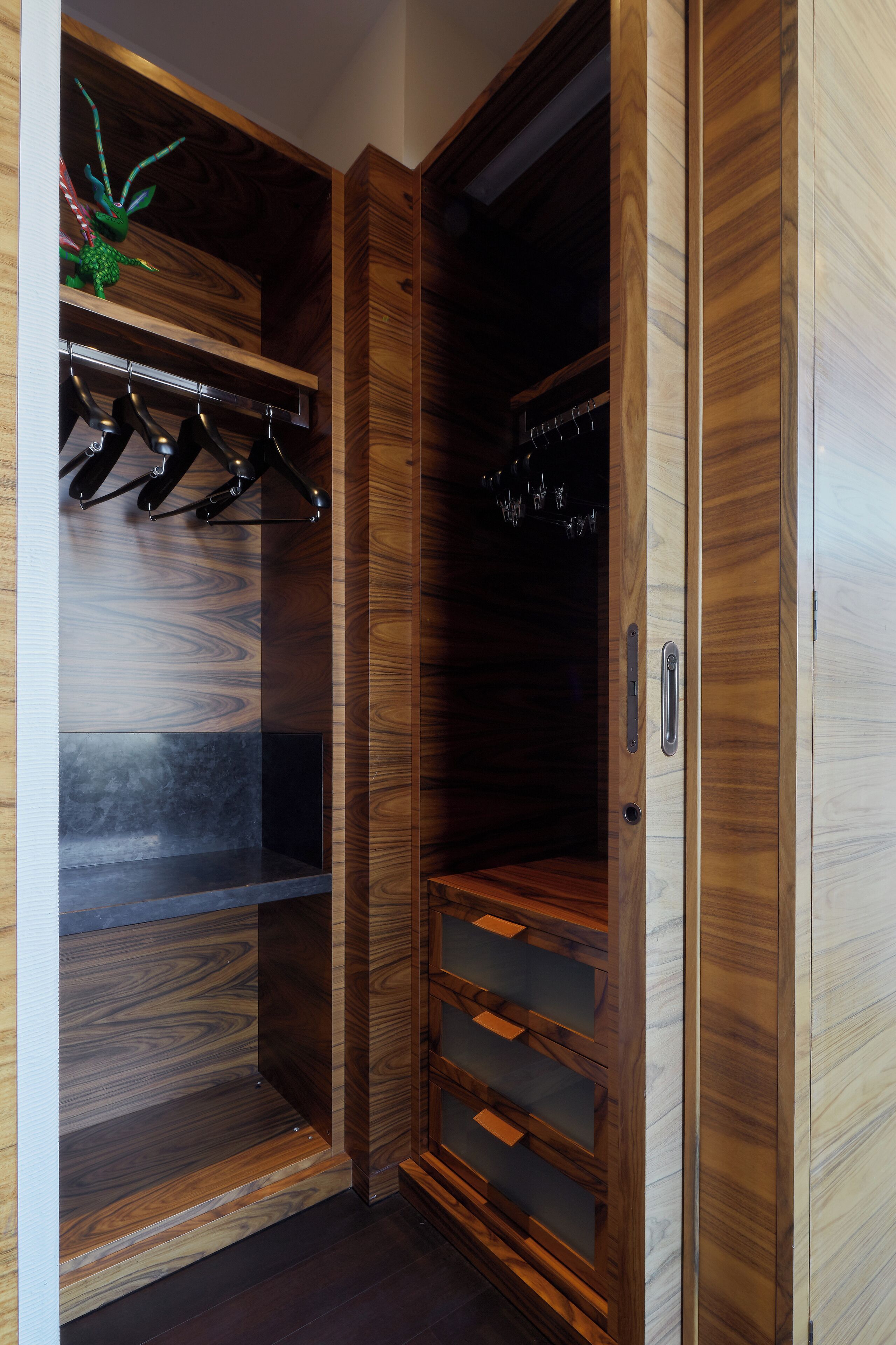 Un armario de madera con varios estantes y espacio para colgar.