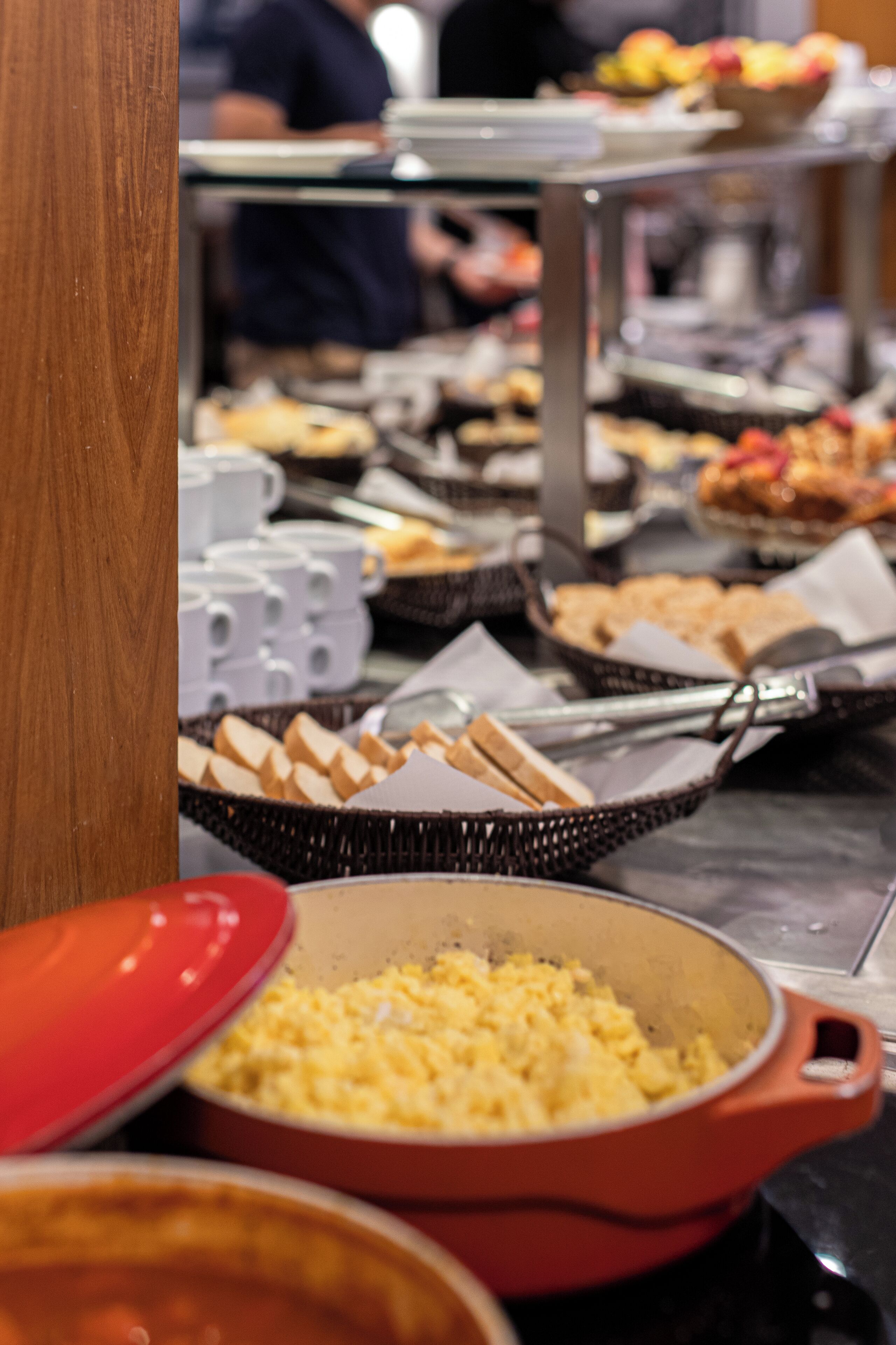 A buffet with various food items and utensils.