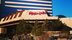 A hotel with a prominent 'Mystic Lake' sign on the facade, featuring a modern architectural design with horizontal lines and a flat roof. - Hampton Inn Minneapolis/Shakopee (Shakopee)