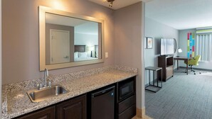 A modern kitchen with granite countertops, a built-in sink, and a microwave. - Hampton Inn Minneapolis/Shakopee (Shakopee)