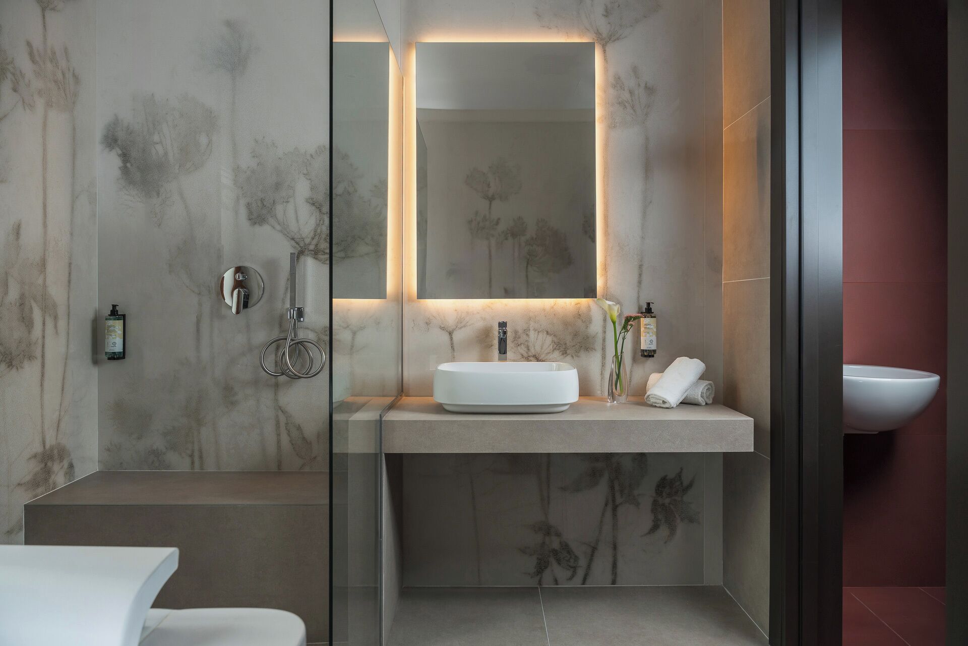 Une salle de bain moderne avec un grand miroir, un lavabo rond et un autre lavabo séparé.