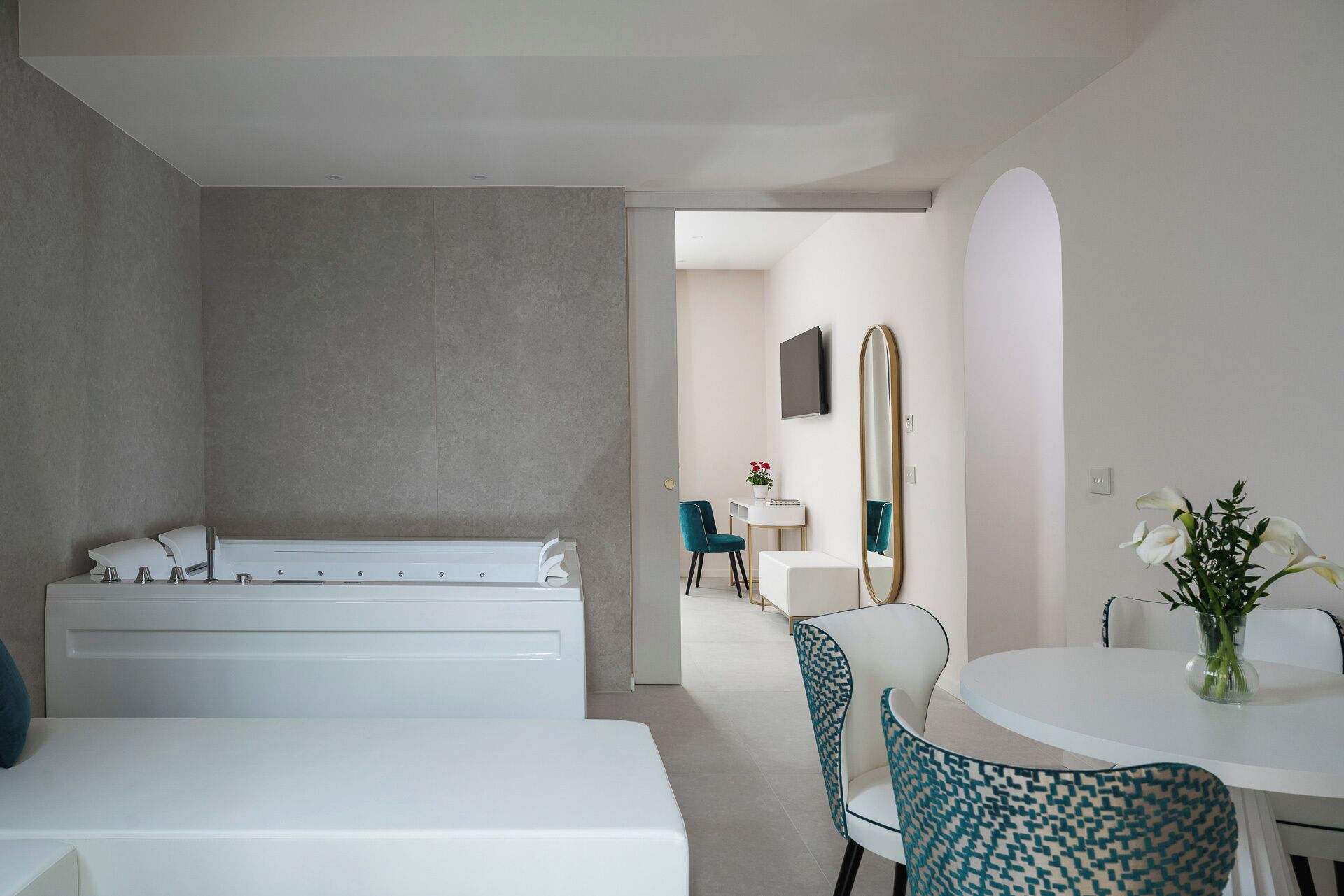 deluxe suite with jacuzzi | living area | 50-inch smart tv with satellite channels