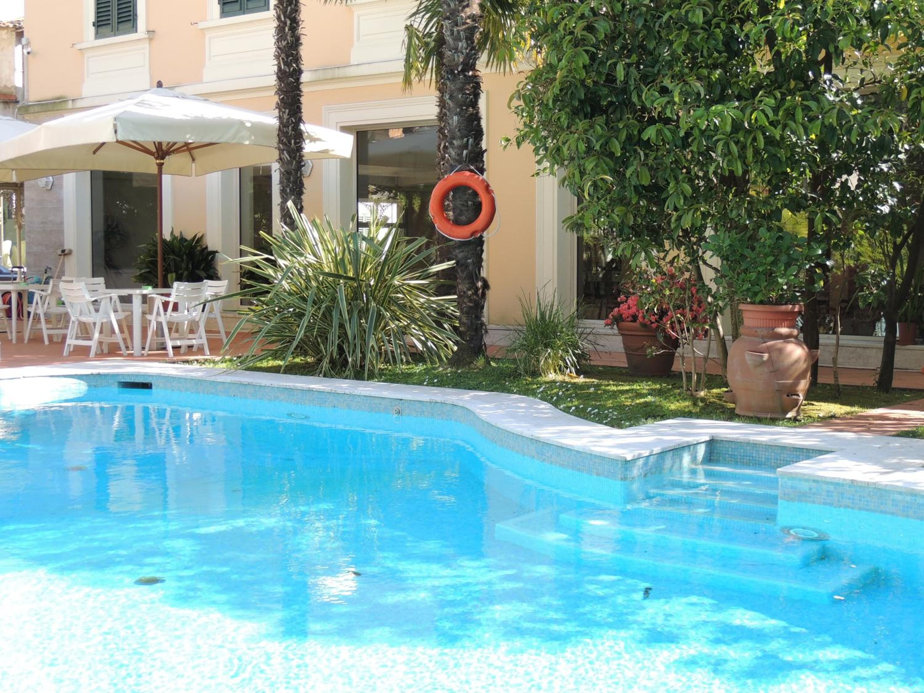 Outdoor pool, open 9:30 AM to 7:00 PM, pool umbrellas, pool loungers