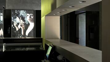 A modern interior with a large digital display, recessed lighting, and a minimalist design.