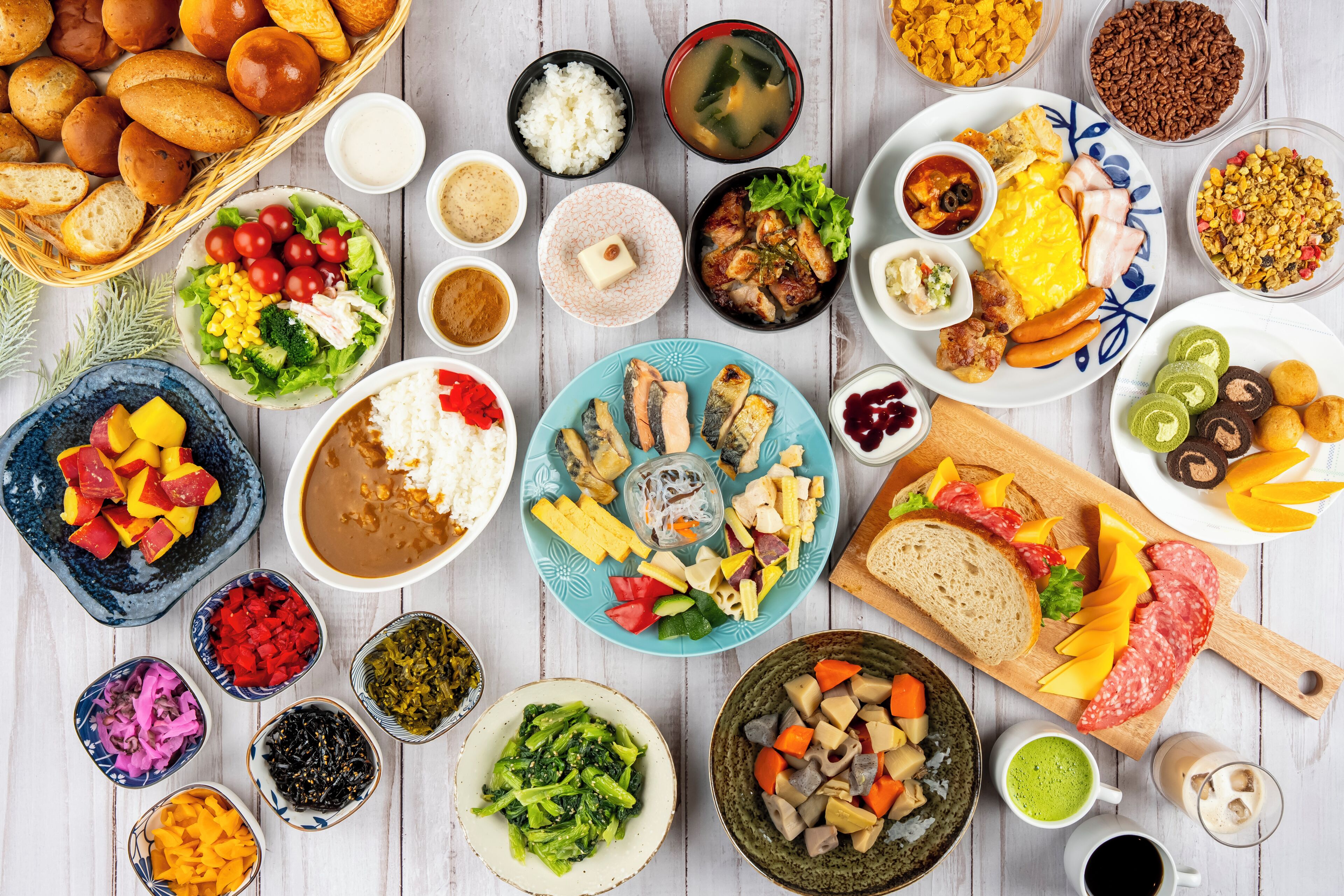 A variety of dishes and food items arranged on a table.
