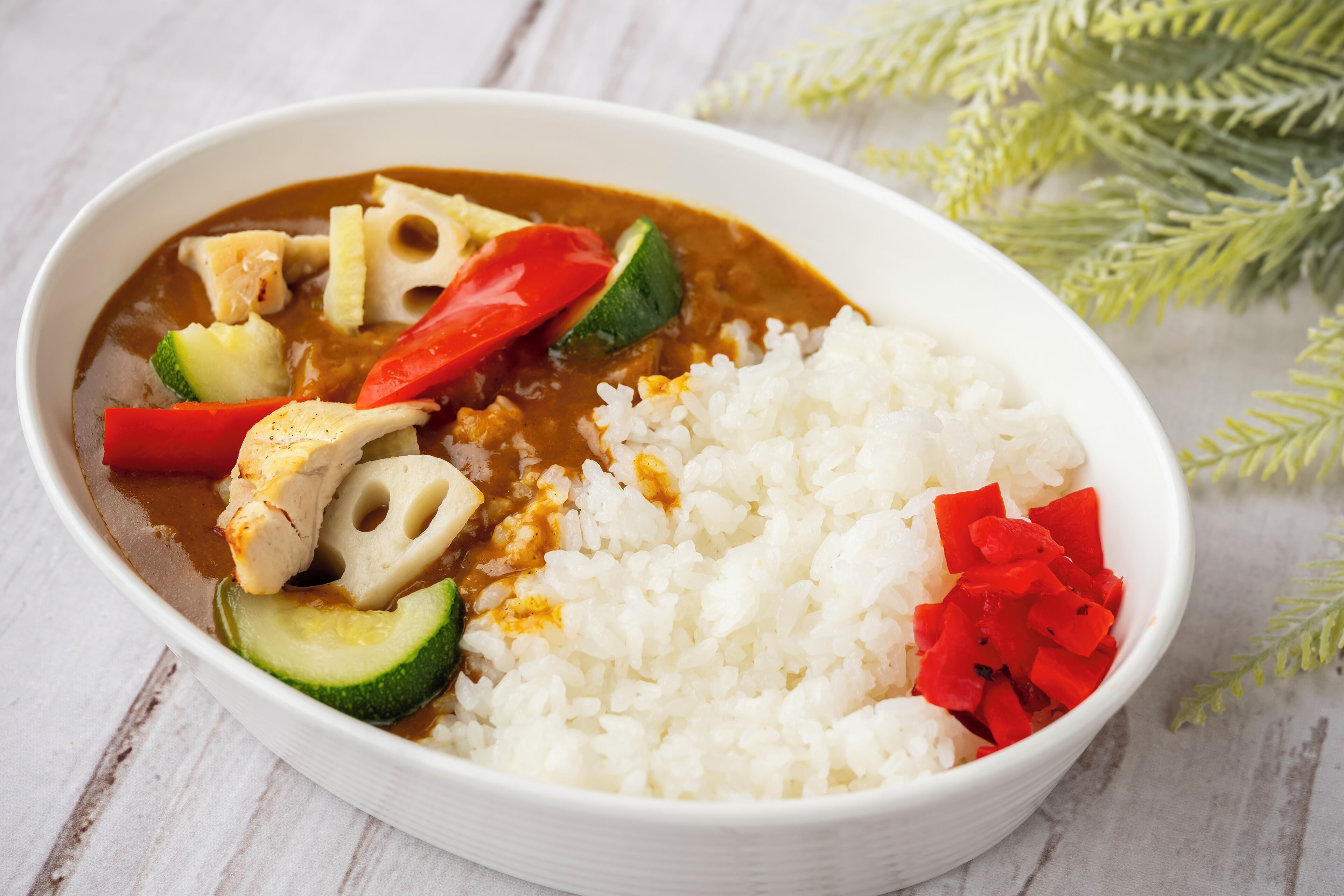 A bowl of food with rice and vegetables.