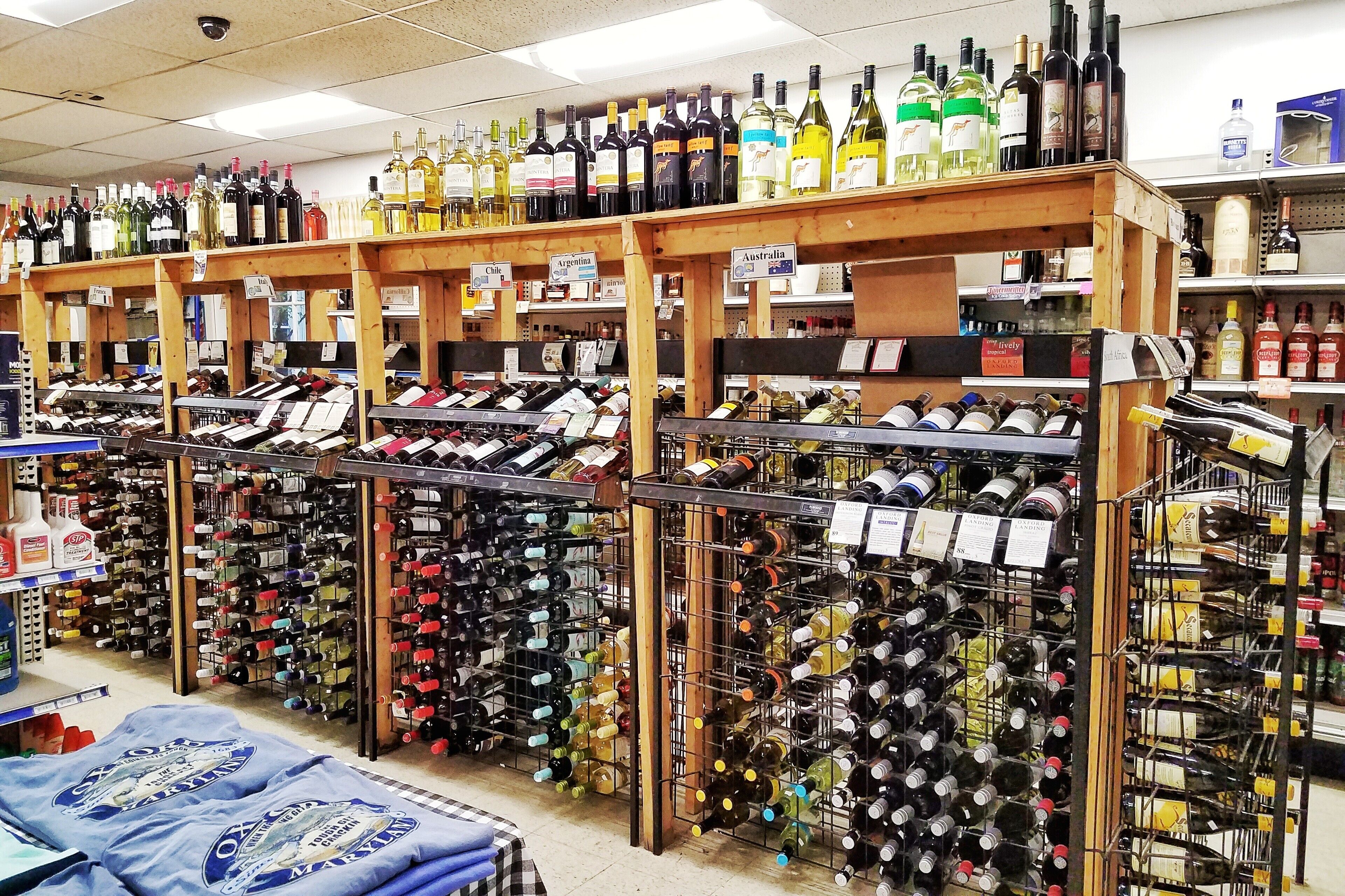 A wine store with shelves of wine bottles organized by country.