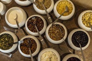 A variety of food items in bowls, including nuts, seeds, and dried fruits. - The Lodge Billund (Billund)